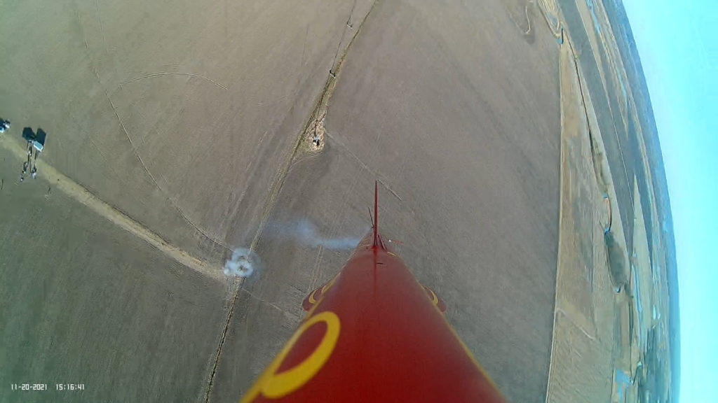 Frame of on-board video from Gravity's Just a Habit showing corkscrew exhaust trail and partial drag separation of booster